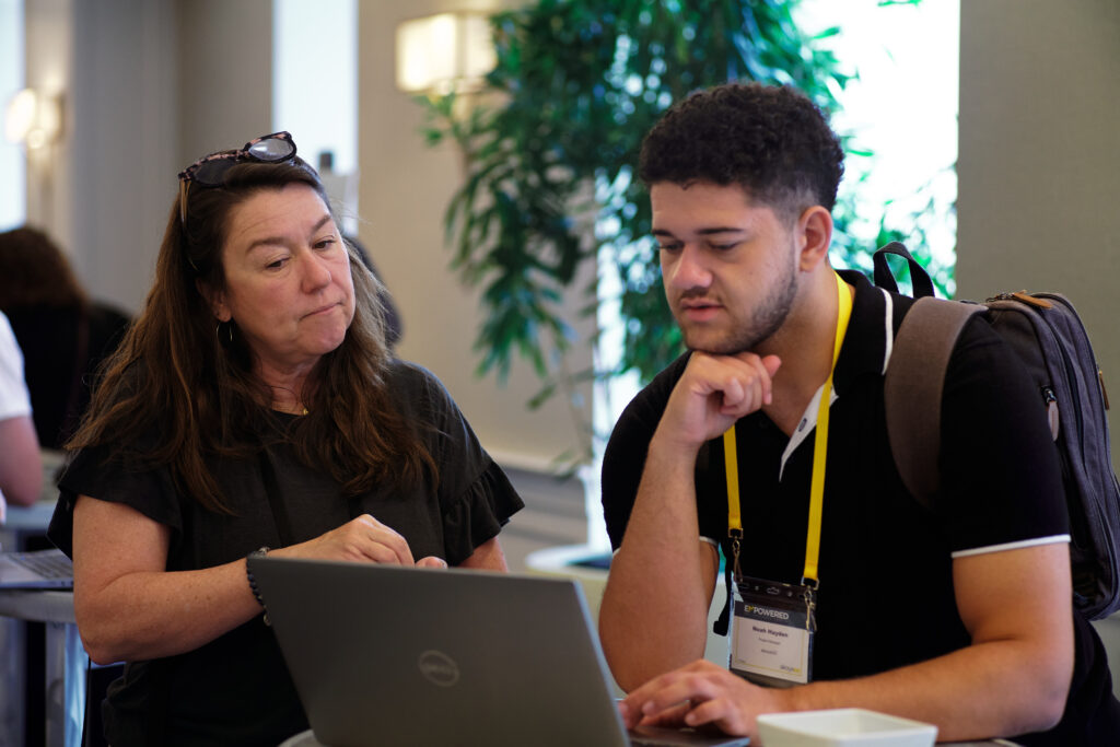 akoyaGO staff member helping an akoyaGO client at EMPOWERED 2025